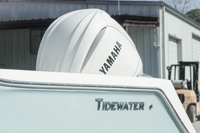 Slide: The Image of 2026 Tidewater 232 CC Adventure boat with Yamaha engine in a marina setting. - 5