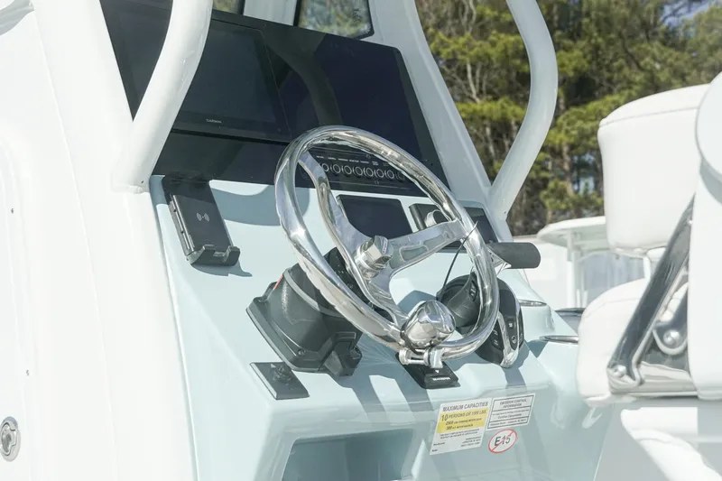 Slide: The Image of Steering console of 2026 Tidewater 232 CC Adventure boat with modern controls. - 7