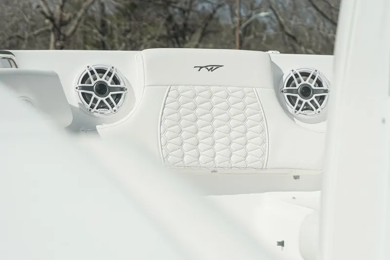 Slide: The Image of 2026 Tidewater 232 CC Adventure boat interior with speakers and quilted upholstery. - 8