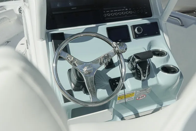 Slide: The Image of Steering console of 2026 Tidewater 232 CC Adventure boat with modern controls. - 9