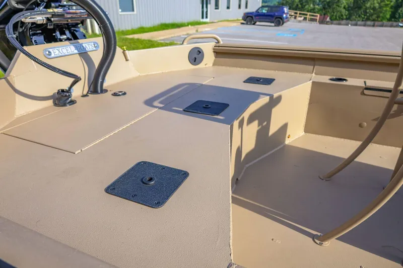 Slide: The Image of 2026 Excel Switchblade boat interior with seating and equipment, parked outdoors. - 7
