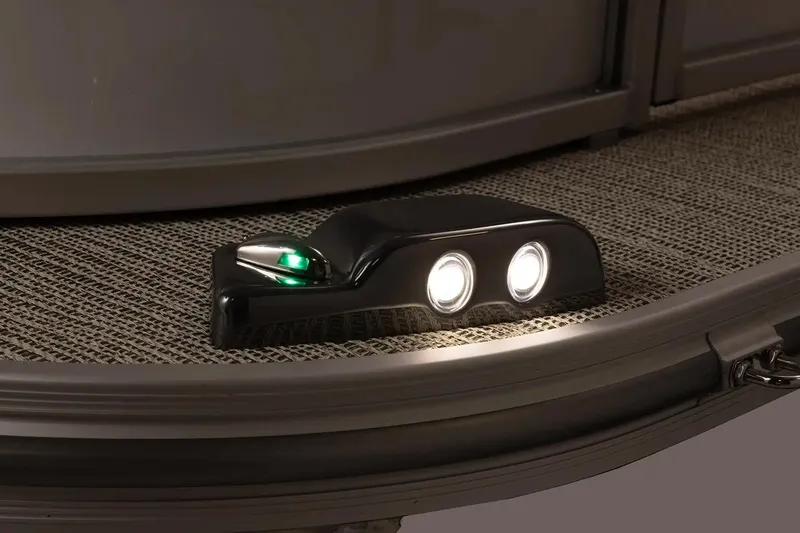 Slide: The Image of 2025 SunCatcher Fusion 324RCX boat deck with illuminated navigation lights. - 10