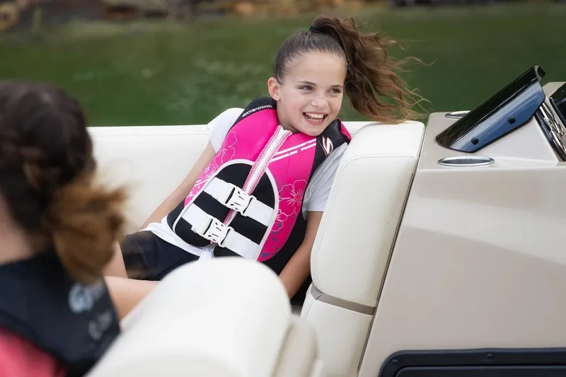 Slide: The Image of Girl smiling on a SunCatcher Fusion 324RCX boat, wearing a pink life jacket. - 9