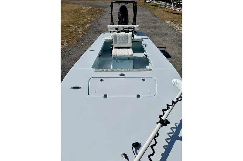 Slide: The Image of 2022 Beavertail Skiffs Vengeance 18 boat, featuring a sleek deck and seating arrangement. - 12