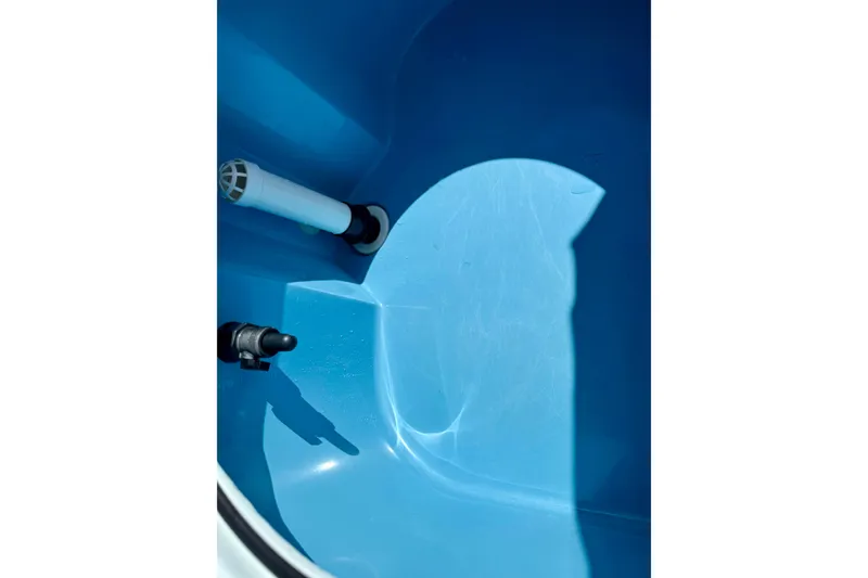 Slide: The Image of Interior view of 2022 Beavertail Skiffs Vengeance 18 boat's blue compartment. - 20