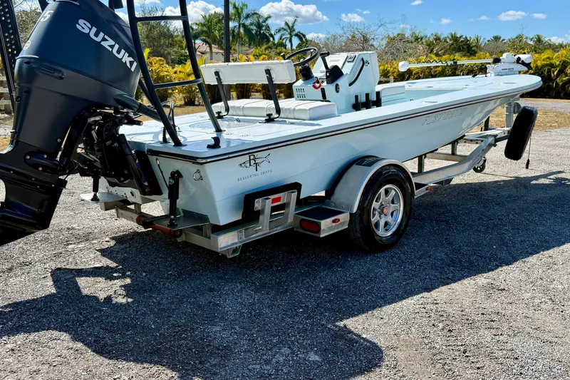 Slide: The Image of 2022 Beavertail Skiffs Vengeance 18 with Suzuki engine on trailer, outdoors. - 25