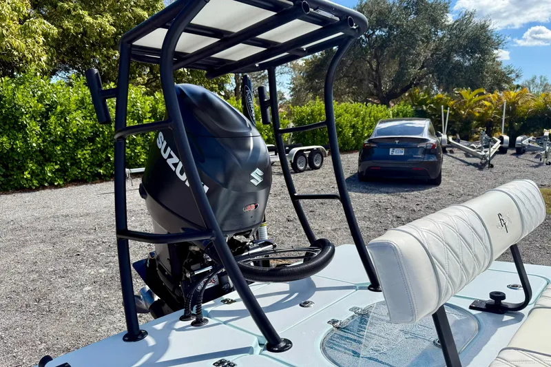 Slide: The Image of 2022 Beavertail Skiffs Vengeance 18 with Suzuki outboard motor, parked outdoors. - 28