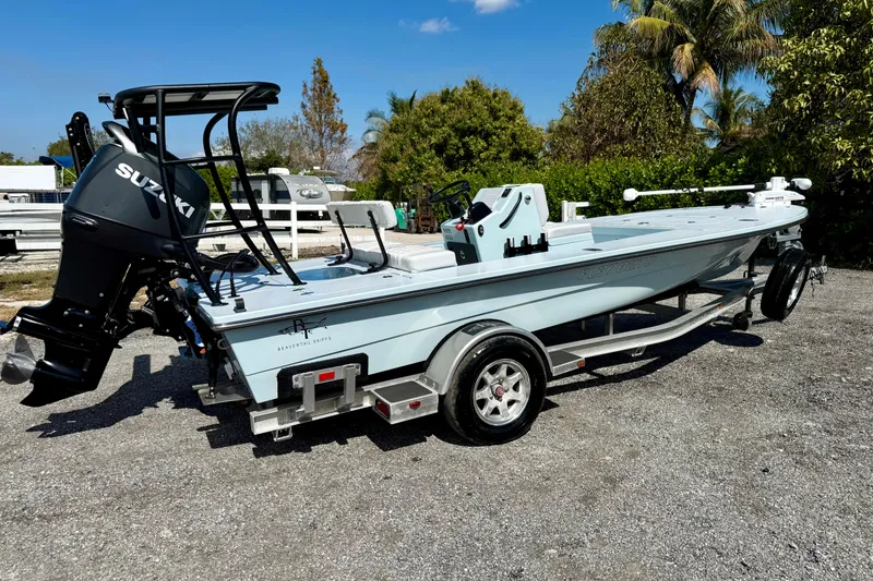 Slide: The Image of 2022 Beavertail Skiffs Vengeance 18 with Suzuki engine on trailer, outdoors. - 29