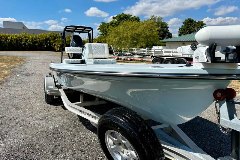 Slide: The Image of 2022 Beavertail Skiffs Vengeance 18 on trailer, parked outdoors under blue sky. - 10