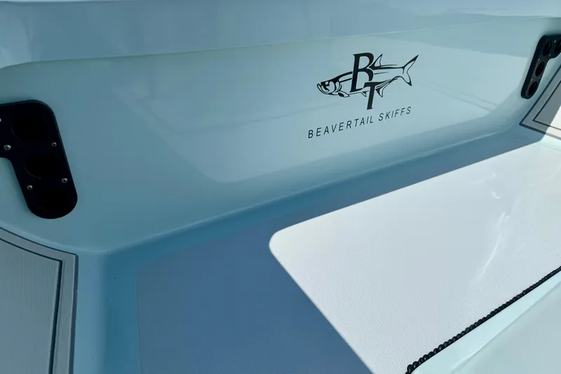 Slide: The Image of 2022 Beavertail Skiffs Vengeance 18 boat interior with logo and rod holders. - 16