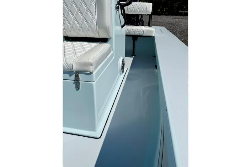Slide: The Image of 2022 Beavertail Skiffs Vengeance 18 interior with white quilted seating. - 17