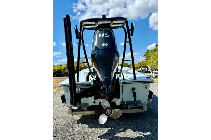 Slide: The Image of 2022 Beavertail Skiffs Vengeance 18 with 115 HP engine, rear view under blue sky. - 30
