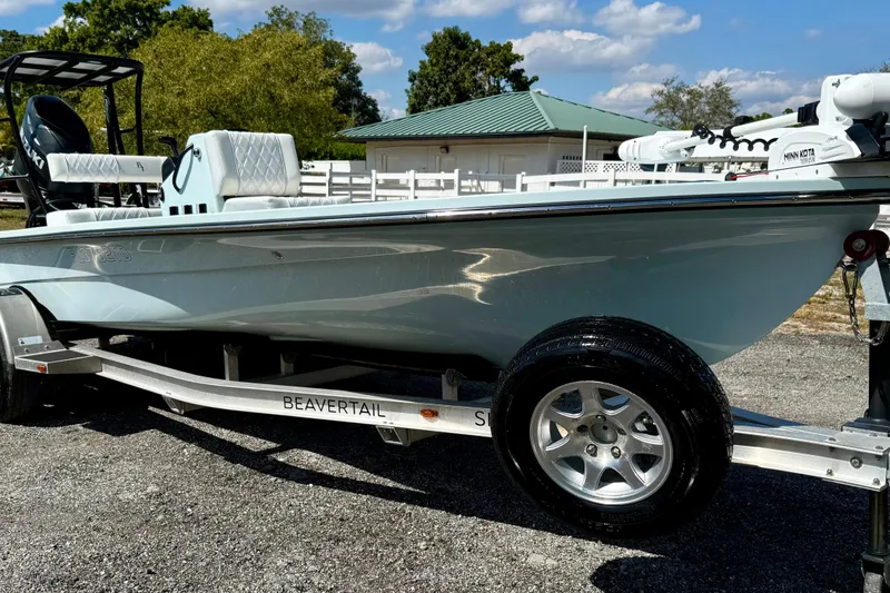 Slide: The Image of 2022 Beavertail Skiffs Vengeance 18 on trailer, parked outdoors under blue sky. - 4