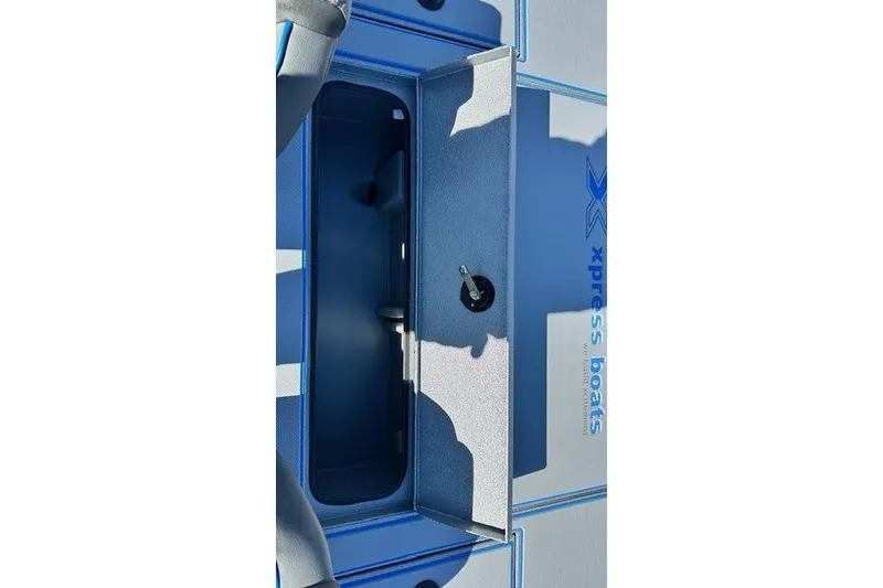 Slide: The Image of 2026 Express H20C boat storage compartment with key, featuring Xpress Boats branding. - 11