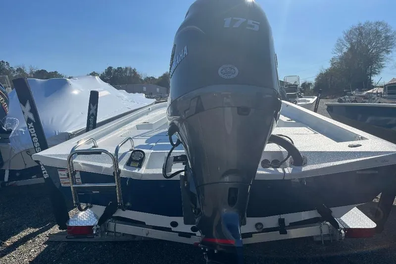 Slide: The Image of 2026 Xpress H22B Bay boat with Yamaha 175 engine, parked outdoors. - 7