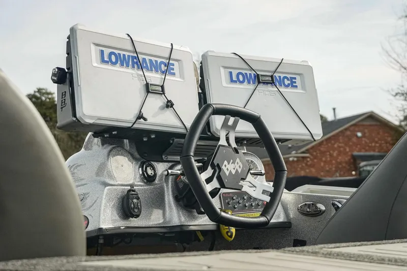 Slide: The Image of 2023 Bass Cat Puma STS dashboard with dual Lowrance displays and custom steering wheel. - 11