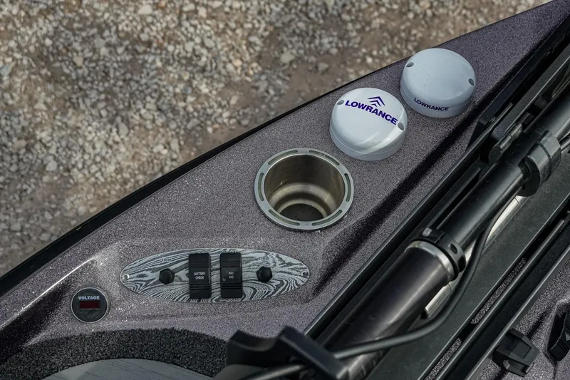 Slide: The Image of 2023 Bass Cat Puma STS boat dashboard with Lowrance equipment and control switches. - 23