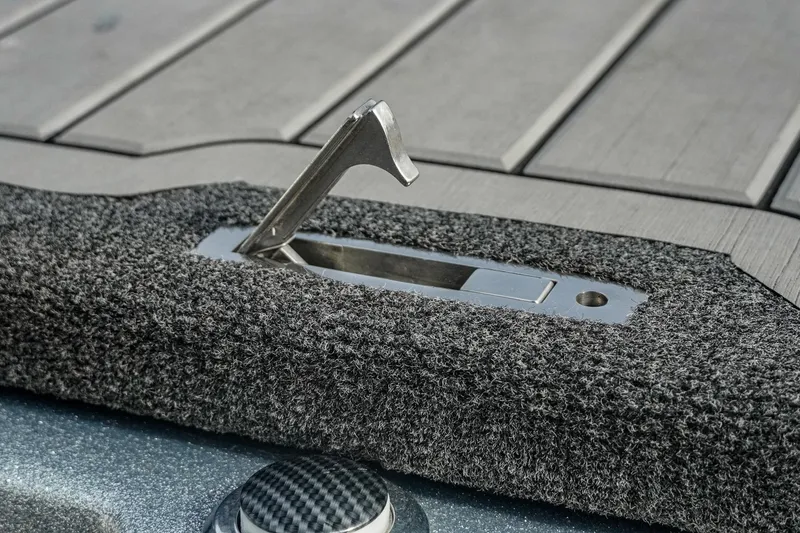 Slide: The Image of 2023 Bass Cat Puma STS boat latch detail with textured surface. - 25
