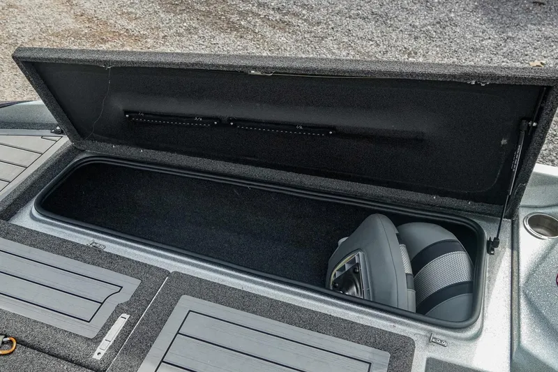 Slide: The Image of 2023 Bass Cat Puma STS storage compartment with open lid, showcasing spacious interior. - 26