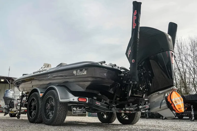 Slide: The Image of 2023 Bass Cat Puma STS boat on trailer, rear view, showcasing sleek design and powerful engine. - 4
