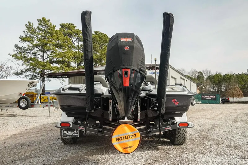 Slide: The Image of 2023 Bass Cat Puma STS boat rear view with motor cover and caution sign. - 5