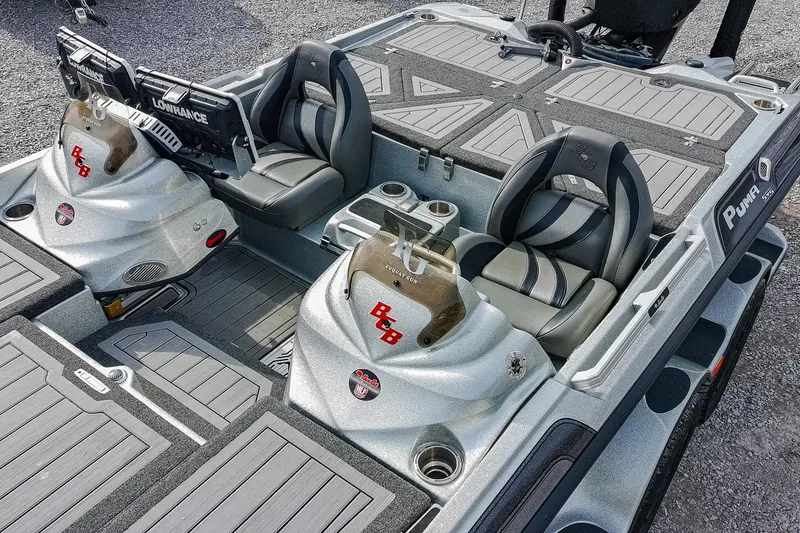 Slide: The Image of 2023 Bass Cat Puma STS boat interior with dual seats and advanced navigation systems. - 7