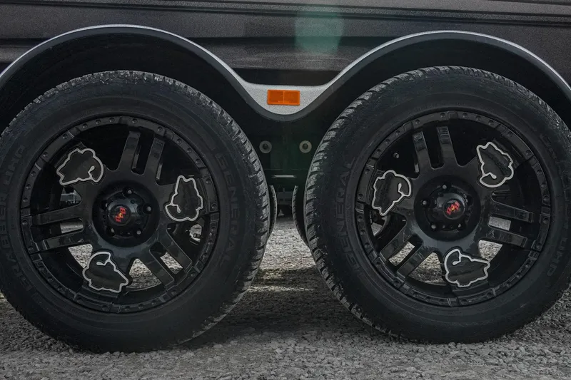 Slide: The Image of 2023 Bass Cat Puma STS trailer wheels with custom black rims and unique design. - 8