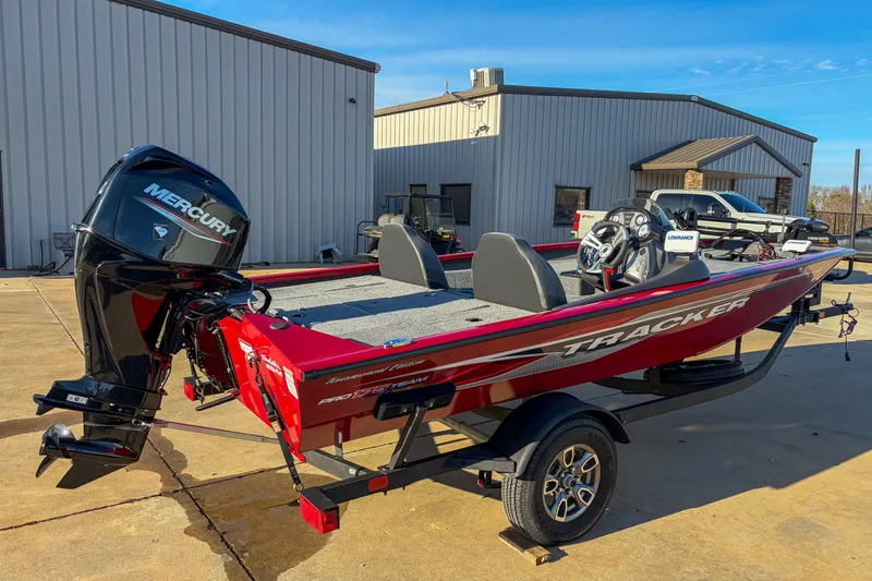 Slide: The Image of 2024 Tracker Pro Team 175 TXW Tournament Edition boat with Mercury engine, parked outdoors. - 4