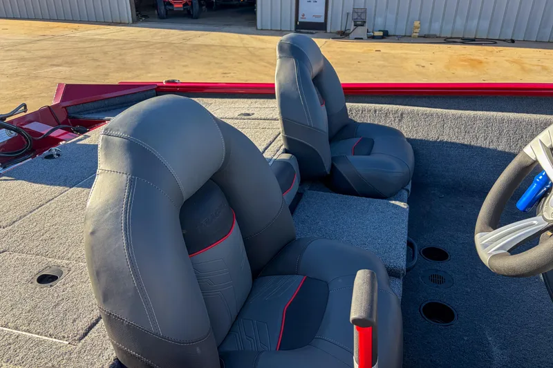 Slide: The Image of 2024 Tracker Pro Team 175 TXW Tournament Edition boat interior with gray seats and steering wheel. - 8