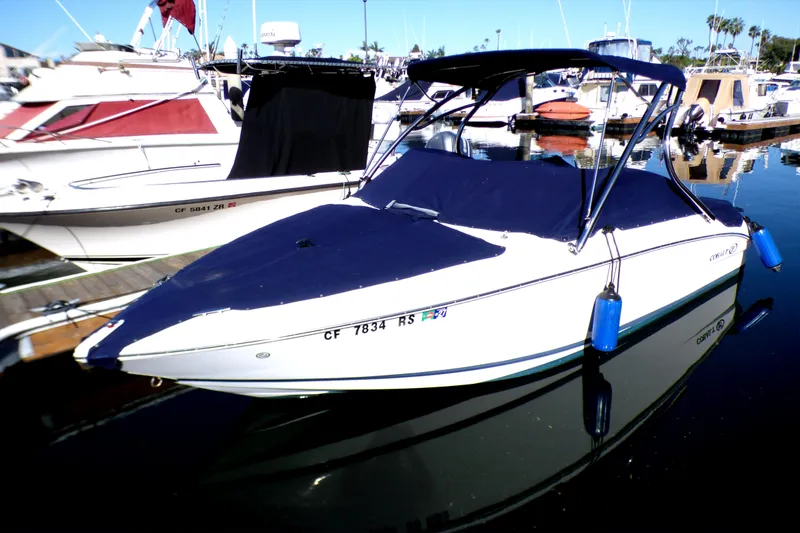 Slide: The Image of 2008 Cobalt 212 boat docked in marina, covered with blue canopy. - 0