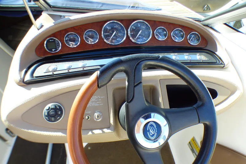 Slide: The Image of Dashboard and steering wheel of a 2008 Cobalt 212 boat, featuring gauges and controls. - 11