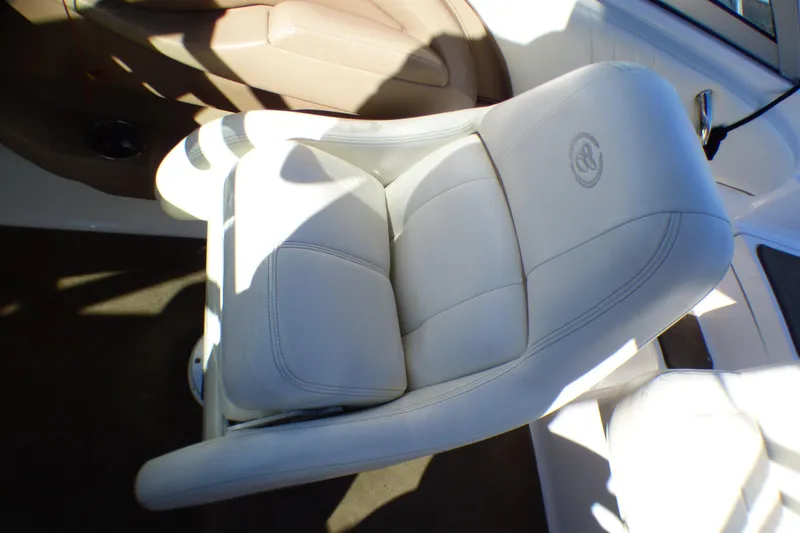 Slide: The Image of White leather seat in 2008 Cobalt 212 boat interior, featuring logo embroidery. - 12