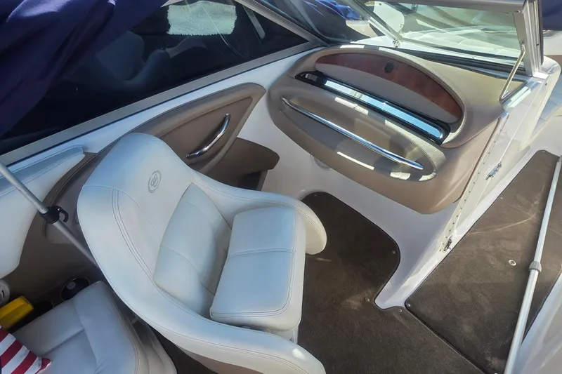 Slide: The Image of Interior of a 2008 Cobalt 212 boat featuring a white leather seat and dashboard. - 13
