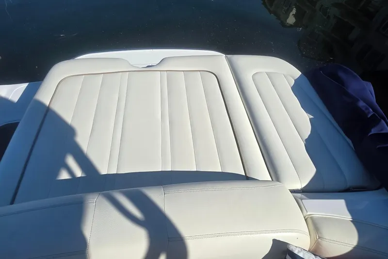 Slide: The Image of 2008 Cobalt 212 boat with white leather seating, docked by the water. - 15