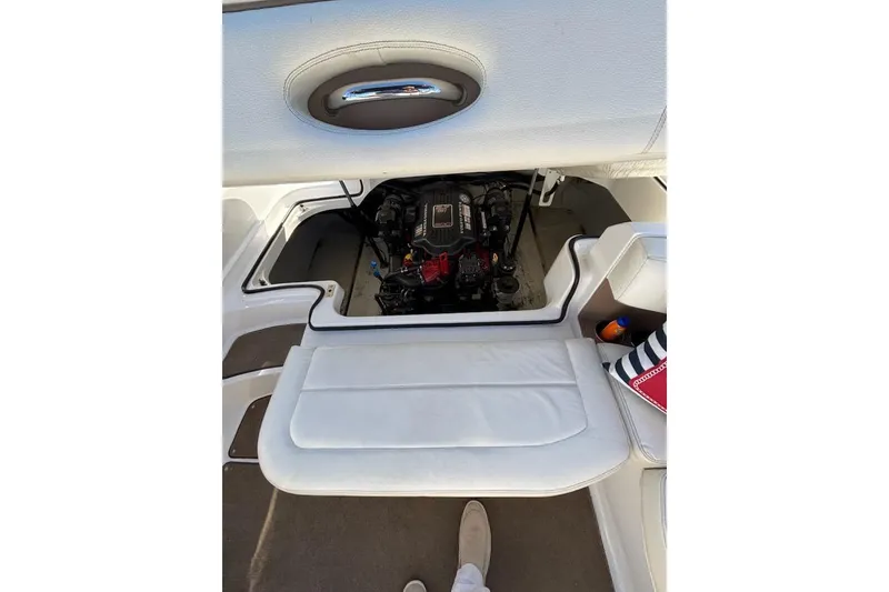Slide: The Image of 2008 Cobalt 212 boat engine compartment with white seating and storage area. - 17