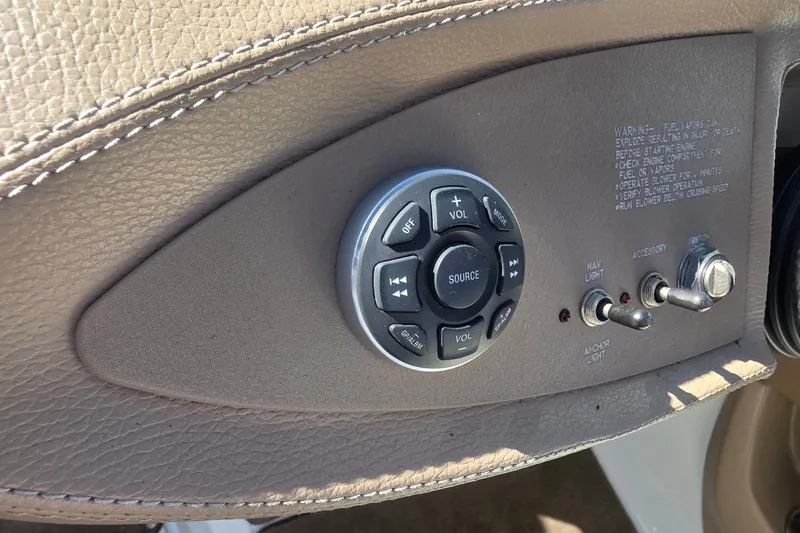 Slide: The Image of 2008 Cobalt 212 boat control panel with buttons and switches on beige leather. - 29