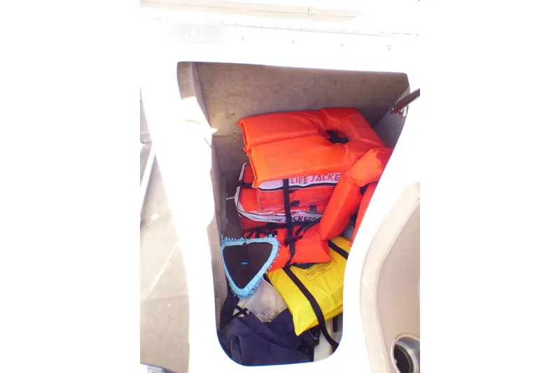 Slide: The Image of Storage compartment in 2008 Cobalt 212 boat with life jackets and safety gear. - 30