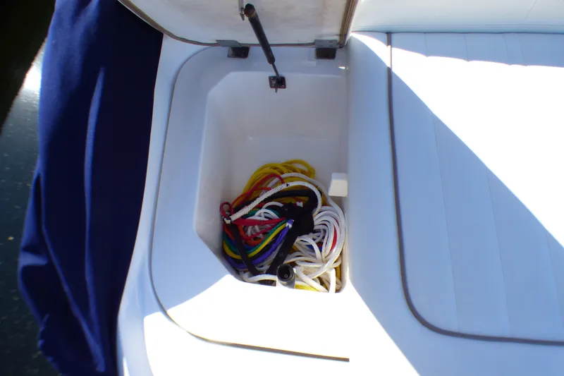 Slide: The Image of Storage compartment on a 2008 Cobalt 212 boat with colorful ropes inside. - 34