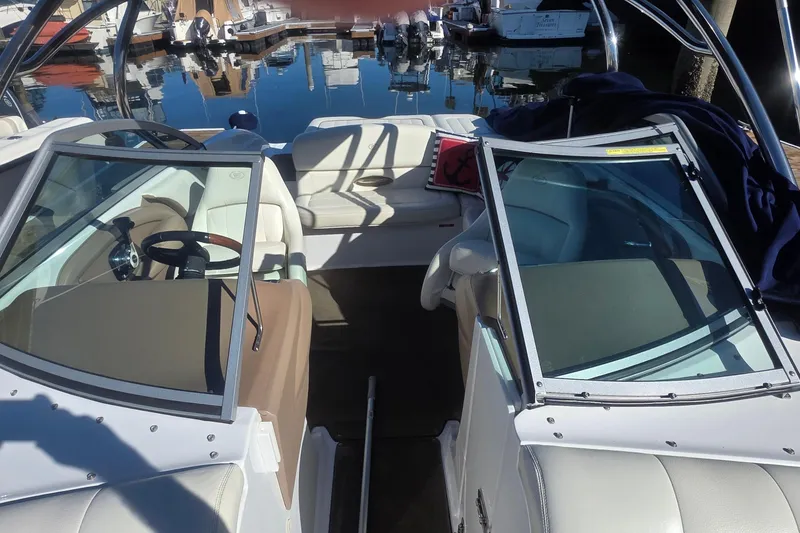 Slide: The Image of 2008 Cobalt 212 boat interior with steering wheel, docked at marina. - 6