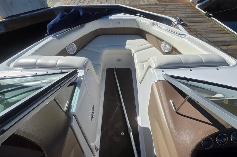 Slide: The Image of Interior of a 2008 Cobalt 212 boat with cushioned seating and sleek design. - 8