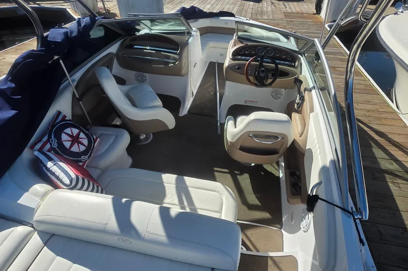 Slide: The Image of Interior of a 2008 Cobalt 212 boat with white seating and nautical-themed pillows. - 9
