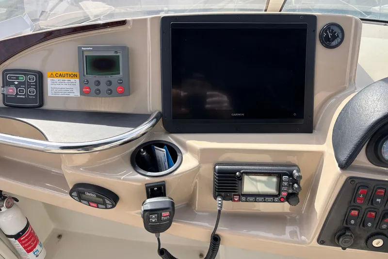 Slide: The Image of Control panel of a 2005 Carver 41 Cockpit Motor Yacht with navigation equipment. - 12
