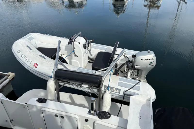 Slide: The Image of 2005 Carver 41 Cockpit Motor Yacht with inflatable dinghy and Honda outboard motor. - 15