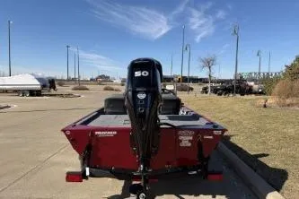 Slide: The Image of 2024 Tracker Bass Tracker Classic XL boat with 50 HP engine, parked outdoors. - 5
