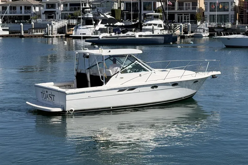 The Image of 2003 Tiara 3100 Open yacht docked in a marina, surrounded by other boats. - 0