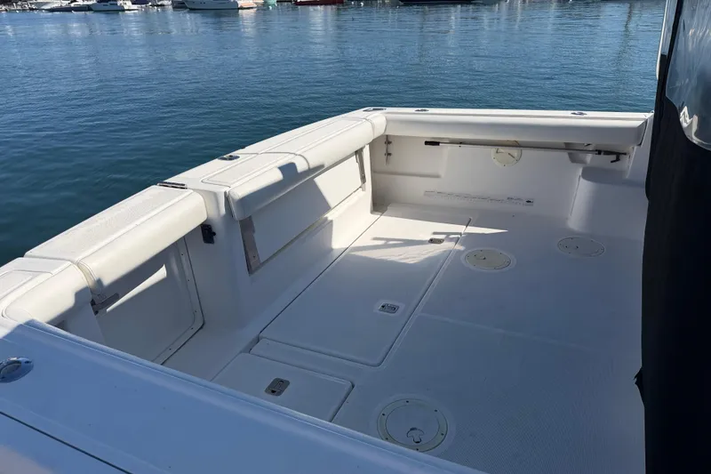 Slide: The Image of 2003 Tiara 3100 Open boat deck with seating, docked in a marina. - 13