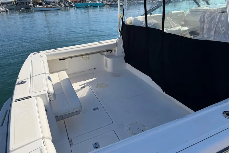 Slide: The Image of Spacious deck of a 2003 Tiara 3100 Open boat, docked in a marina. - 14