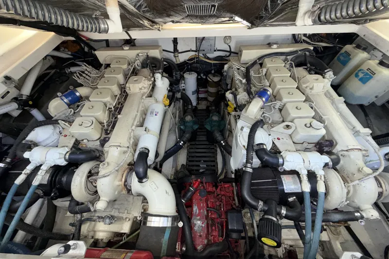 Slide: The Image of Engine room of a 2003 Tiara 3100 Open boat, showcasing dual engines and mechanical components. - 18