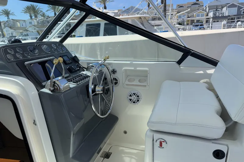 Slide: The Image of 2003 Tiara 3100 Open boat cockpit with steering wheel and control panel. - 2