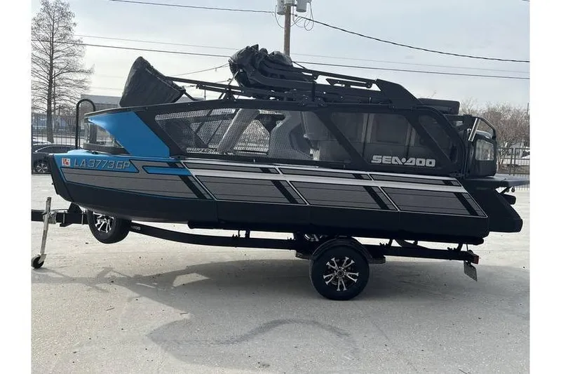 Slide: The Image of 2022 Sea Doo Switch 18 pontoon boat on trailer, side view. - 10
